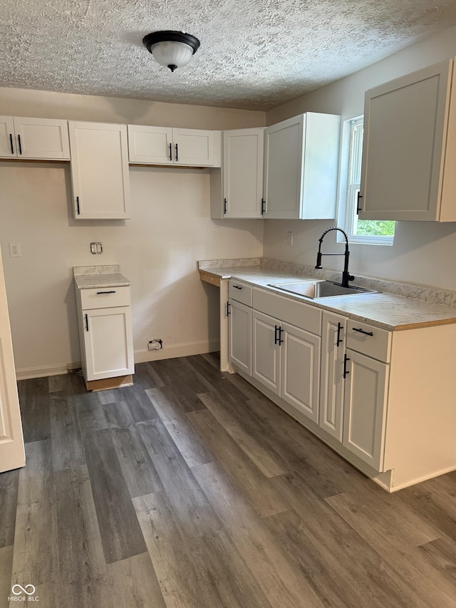 8434 Meadowlark Dr, Indianapolis, IN 46226 - kitchen with dark wood-type flooring, white cabinetry, light countertops, and a textured ceiling