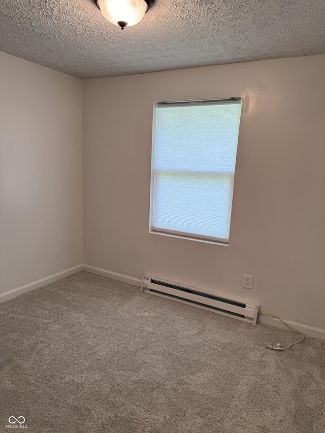 8434 Meadowlark Dr, Indianapolis, IN 46226 - empty room featuring a baseboard heating unit, carpet flooring, and a textured ceiling