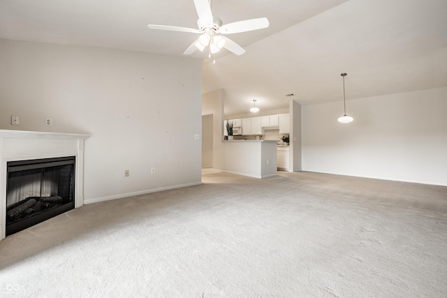 246 Legends Creek Way Apt 207, Indianapolis, IN 46229 - unfurnished living room featuring light colored carpet, a fireplace, ceiling fan, and vaulted ceiling