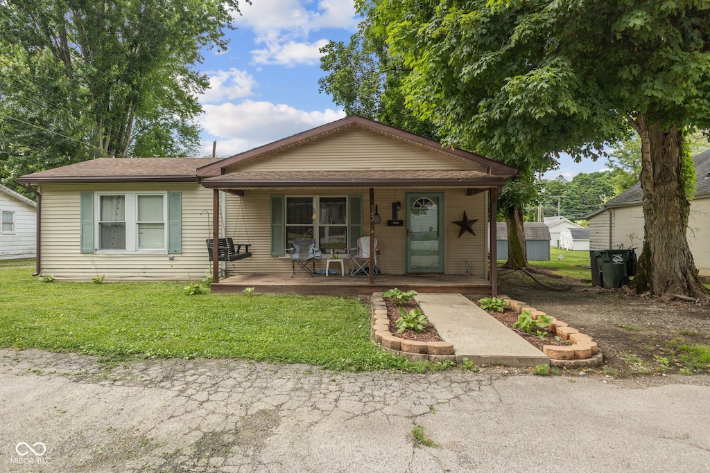 13 S 4th St, Cambridge City, IN 47327 - view of front of house with covered porch and a front lawn