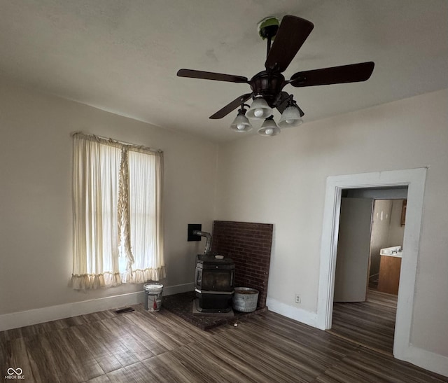 401 S W St, Kempton, IN 46049 - living area featuring a wood stove, wood finished floors, and a ceiling fan