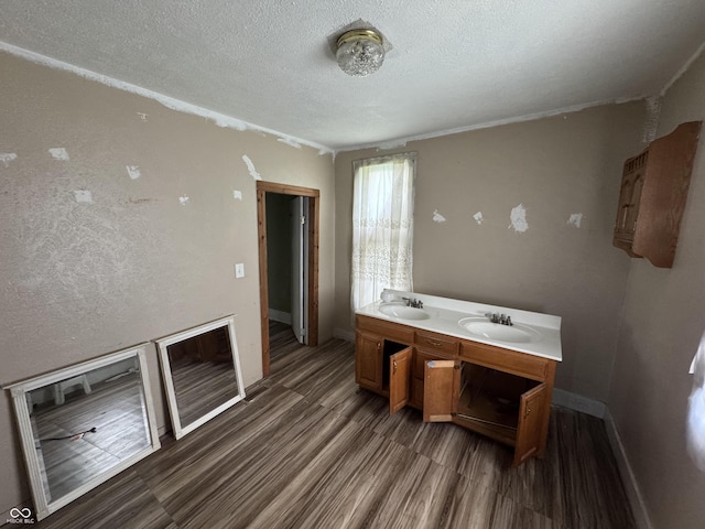 401 S W St, Kempton, IN 46049 - full bathroom with wood finished floors, a textured ceiling, and double vanity