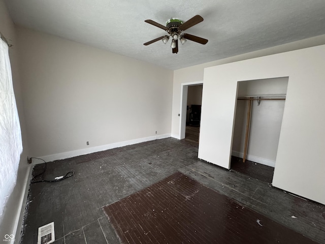 401 S W St, Kempton, IN 46049 - unfurnished bedroom featuring dark wood-style flooring, a ceiling fan, and a closet