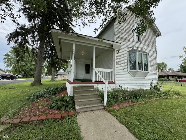 401 S W St, Kempton, IN 46049 - view of front facade featuring a front lawn and covered porch
