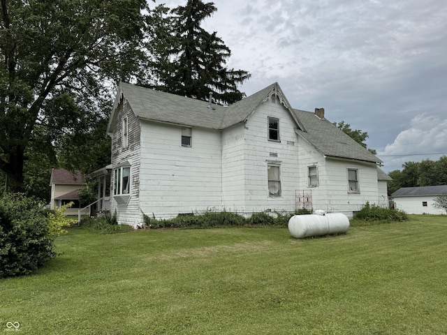 401 S W St, Kempton, IN 46049 - view of home's exterior with a yard, a chimney, and a shingled roof