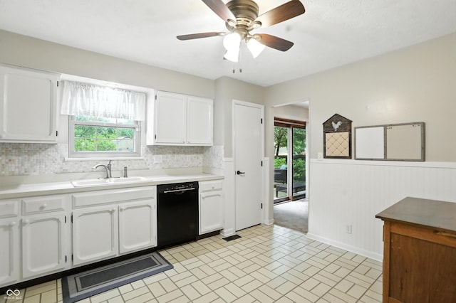 610 Front Royal Dr, Indianapolis, IN 46227 - kitchen featuring dishwasher, white cabinetry, plenty of natural light, a wainscoted wall, and light countertops