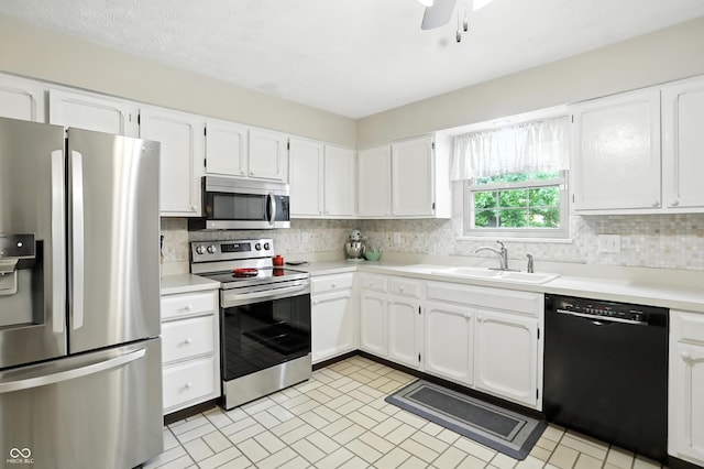 610 Front Royal Dr, Indianapolis, IN 46227 - kitchen with appliances with stainless steel finishes, decorative backsplash, white cabinetry, light countertops, and a ceiling fan
