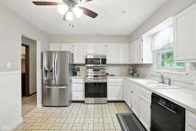 610 Front Royal Dr, Indianapolis, IN 46227 - kitchen with stainless steel appliances, ceiling fan, white cabinets, and tasteful backsplash