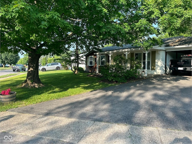 1908 Tennyson Dr, Clarksville, IN 47129 - view of side of property with a lawn, asphalt driveway, and a carport