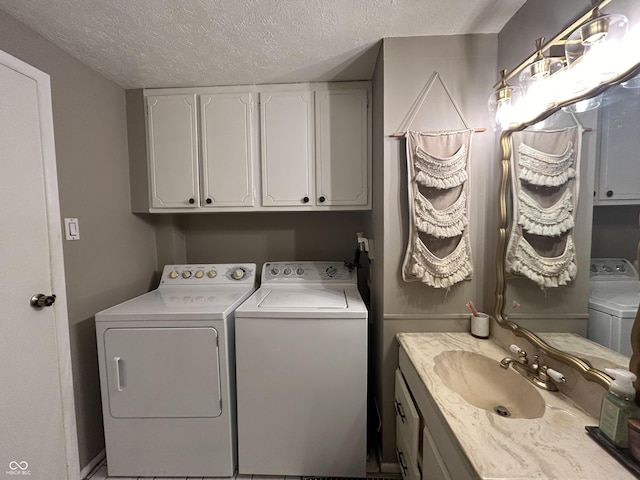 1908 Tennyson Dr, Clarksville, IN 47129 - laundry room featuring washer and clothes dryer, a textured ceiling, and cabinet space