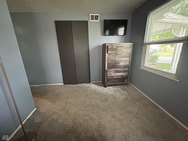 1908 Tennyson Dr, Clarksville, IN 47129 - unfurnished bedroom with carpet flooring and a textured ceiling