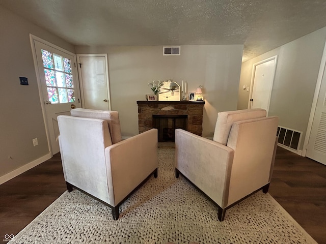 1908 Tennyson Dr, Clarksville, IN 47129 - living area featuring wood finished floors, a fireplace, and a textured ceiling