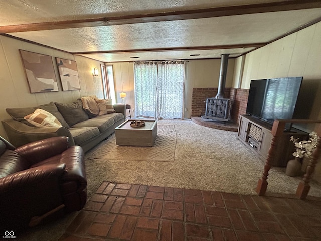 1908 Tennyson Dr, Clarksville, IN 47129 - living room with a wood stove, brick patterned flooring, wood walls, beamed ceiling, and a textured ceiling