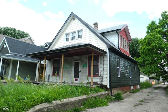 1601 Spann Ave, Indianapolis, IN 46203 - bungalow-style house with a porch and a chimney