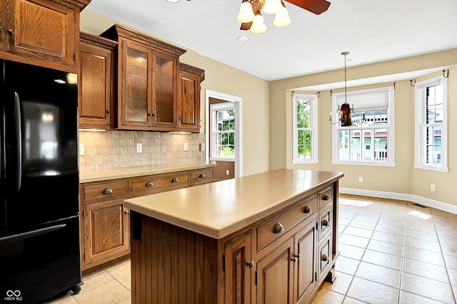 11250 N 600 W, Fountaintown, IN 46130 - kitchen with freestanding refrigerator, light tile patterned floors, healthy amount of natural light, and tasteful backsplash
