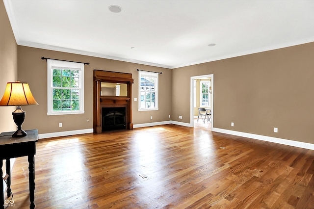 11250 N 600 W, Fountaintown, IN 46130 - unfurnished living room featuring ornamental molding, plenty of natural light, wood finished floors, and a fireplace