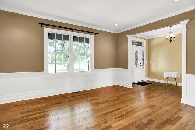 11250 N 600 W, Fountaintown, IN 46130 - entrance foyer featuring wainscoting, wood finished floors, a chandelier, ornamental molding, and recessed lighting