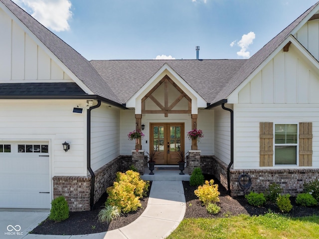 320 Briar Hill Dr, Whiteland, IN 46184 - view of exterior entry with french doors, board and batten siding, a garage, and roof with shingles