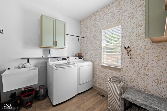 320 Briar Hill Dr, Whiteland, IN 46184 - laundry area featuring cabinet space, light wood-type flooring, separate washer and dryer, and wallpapered walls