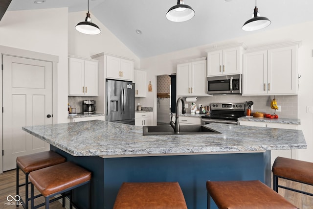 320 Briar Hill Dr, Whiteland, IN 46184 - kitchen featuring stainless steel appliances, white cabinetry, decorative backsplash, a kitchen breakfast bar, and high vaulted ceiling