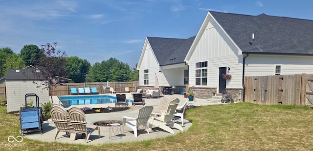 320 Briar Hill Dr, Whiteland, IN 46184 - back of property with board and batten siding, a fenced backyard, a patio area, and a storage shed