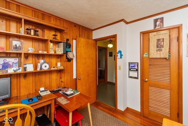 2808 Woodside Dr, Plainfield, IN 46168 - home office with ornamental molding, wood finished floors, wood walls, a textured ceiling, and ceiling fan