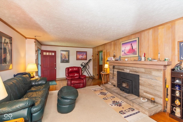 2808 Woodside Dr, Plainfield, IN 46168 - living room featuring wood finished floors, crown molding, a wood stove, a textured ceiling, and wood walls