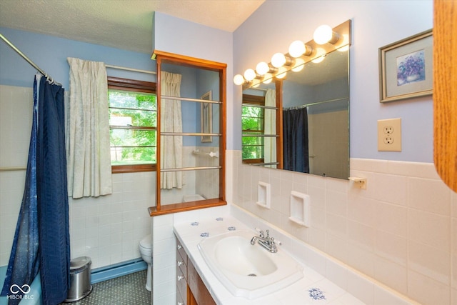 2808 Woodside Dr, Plainfield, IN 46168 - full bathroom featuring tile walls, vanity, a shower with curtain, tile patterned floors, and a wainscoted wall