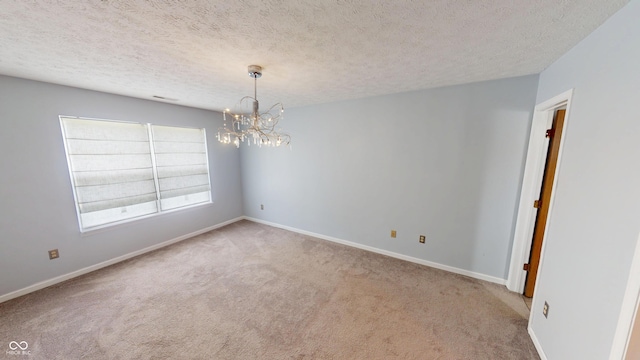 6640 Chipping Ct, Indianapolis, IN 46268 - unfurnished room with carpet flooring, a textured ceiling, and a chandelier