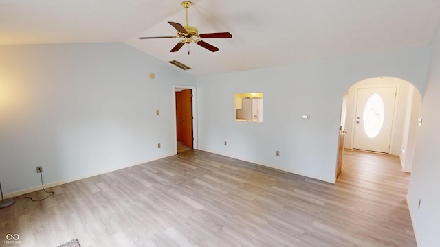 6640 Chipping Ct, Indianapolis, IN 46268 - empty room with arched walkways, ceiling fan, light wood finished floors, and vaulted ceiling