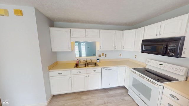 6640 Chipping Ct, Indianapolis, IN 46268 - kitchen with white appliances, light wood-type flooring, and white cabinets
