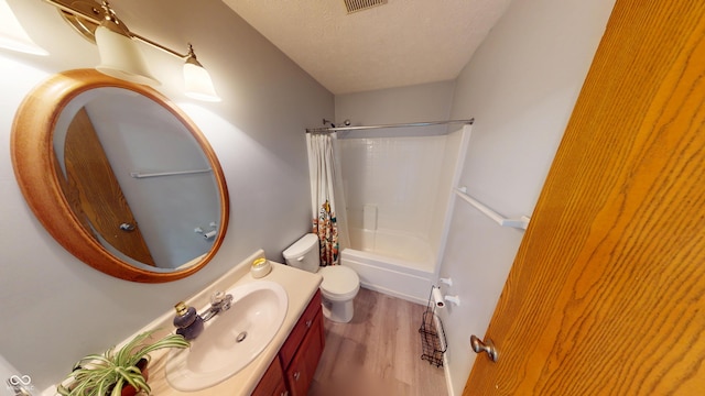 6640 Chipping Ct, Indianapolis, IN 46268 - bathroom featuring wood finished floors, vanity, shower / tub combo, and a textured ceiling