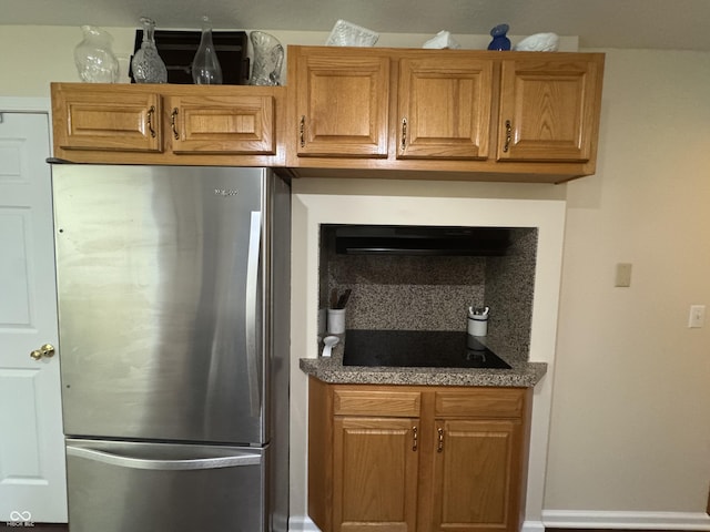 1626 N Nieman Dr, Greensburg, IN 47240 - kitchen featuring freestanding refrigerator, black electric cooktop, and brown cabinets