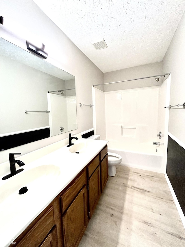 6839 Antelope Dr, Indianapolis, IN 46278 - bathroom featuring wood finished floors, shower / bath combination, double vanity, and a textured ceiling