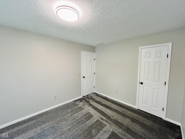 6839 Antelope Dr, Indianapolis, IN 46278 - spare room with dark colored carpet and a textured ceiling