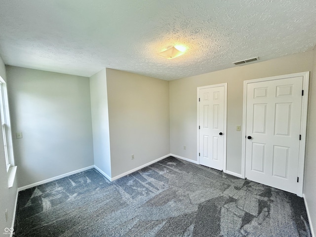 6839 Antelope Dr, Indianapolis, IN 46278 - unfurnished bedroom featuring carpet floors and a textured ceiling