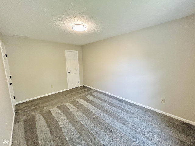 6839 Antelope Dr, Indianapolis, IN 46278 - empty room featuring a textured ceiling and dark colored carpet