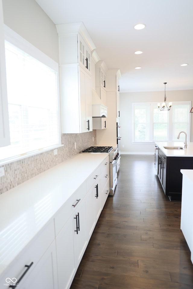 13044 Moorland Ln, Carmel, IN 46074 - kitchen featuring dark wood finished floors, premium range hood, a chandelier, decorative backsplash, and light countertops