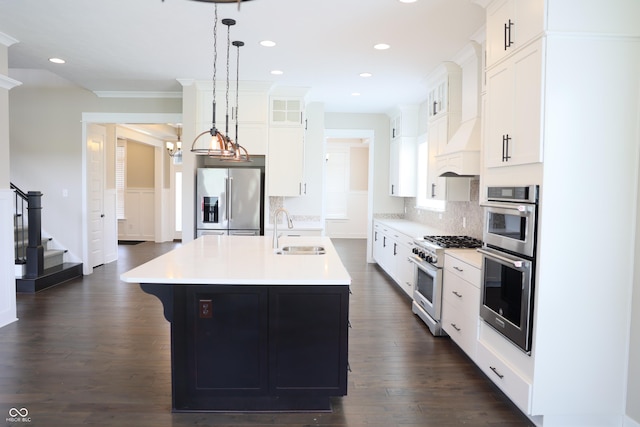 13044 Moorland Ln, Carmel, IN 46074 - kitchen with stainless steel appliances, glass insert cabinets, decorative backsplash, light countertops, and an island with sink