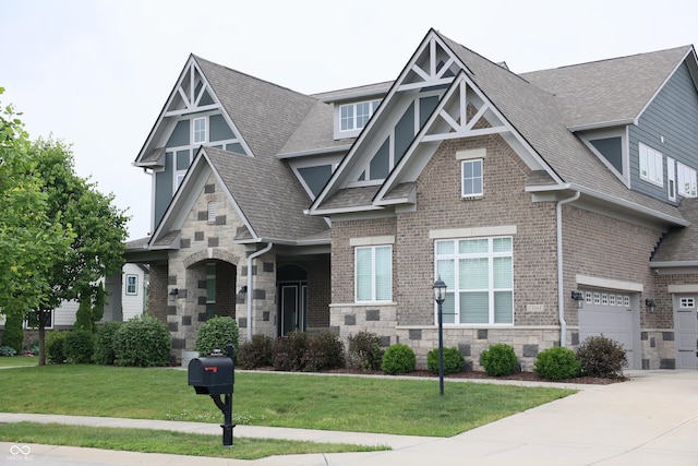 13044 Moorland Ln, Carmel, IN 46074 - view of front of property featuring roof with shingles, stone siding, a front lawn, concrete driveway, and brick siding