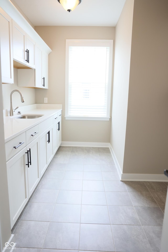 13044 Moorland Ln, Carmel, IN 46074 - kitchen featuring light countertops, light tile patterned floors, and white cabinetry