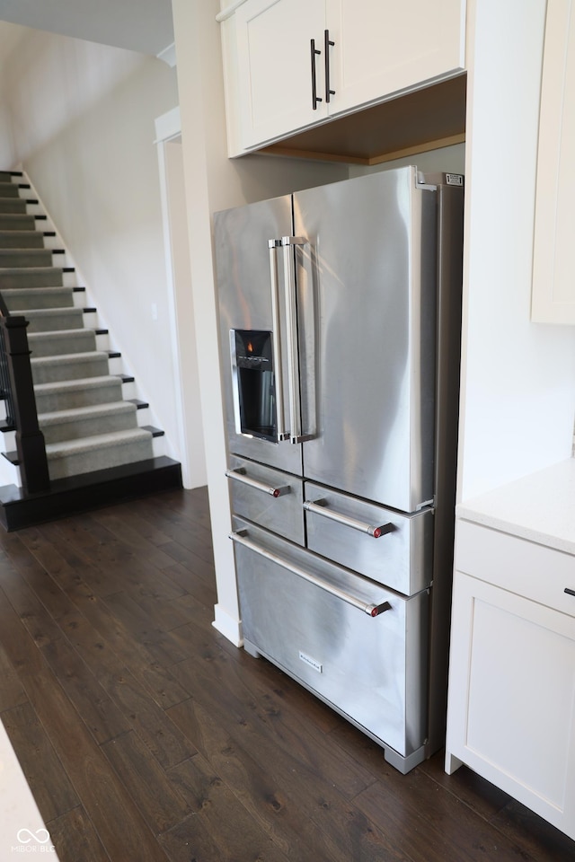 13044 Moorland Ln, Carmel, IN 46074 - kitchen with high quality fridge, dark wood-style floors, and white cabinetry