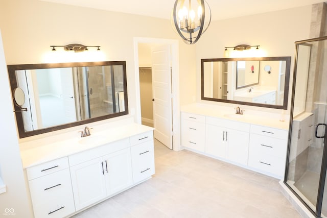 13044 Moorland Ln, Carmel, IN 46074 - bathroom featuring a chandelier, a stall shower, and two vanities