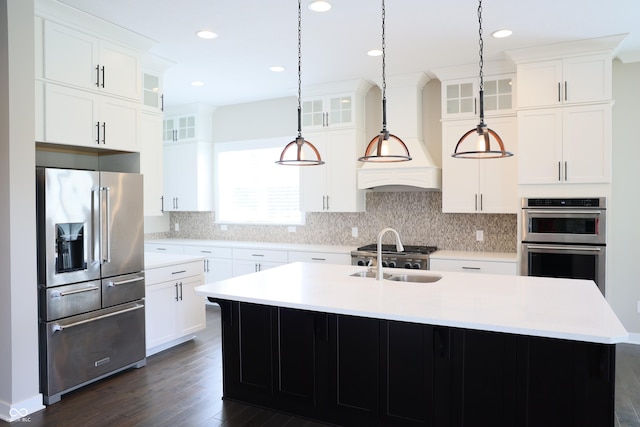 13044 Moorland Ln, Carmel, IN 46074 - kitchen featuring appliances with stainless steel finishes, an island with sink, dark wood-style floors, hanging light fixtures, and recessed lighting