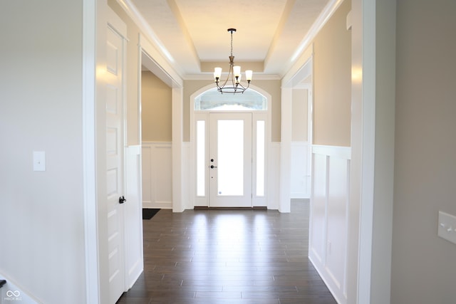 13044 Moorland Ln, Carmel, IN 46074 - foyer entrance featuring a chandelier, healthy amount of natural light, a decorative wall, a raised ceiling, and dark wood-style flooring