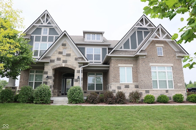 13044 Moorland Ln, Carmel, IN 46074 - english style home featuring a front yard, brick siding, stone siding, and a shingled roof