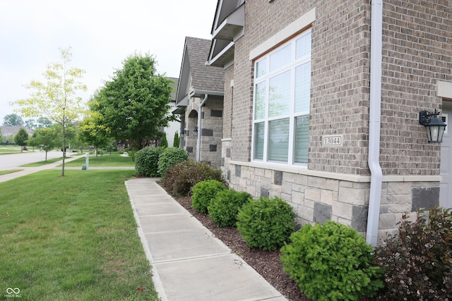 13044 Moorland Ln, Carmel, IN 46074 - view of side of home featuring a lawn, brick siding, stone siding, and a shingled roof