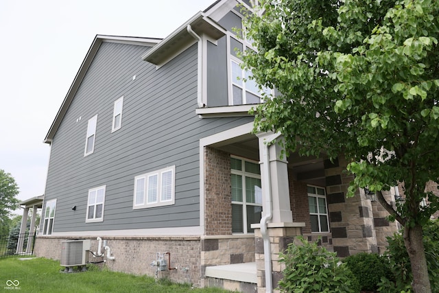 13044 Moorland Ln, Carmel, IN 46074 - view of side of property featuring a central AC unit and brick siding