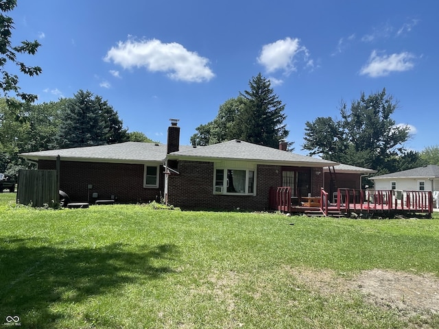 7725 S Oak Dr, Indianapolis, IN 46227 - back of property with a chimney, a wooden deck, a yard, and brick siding