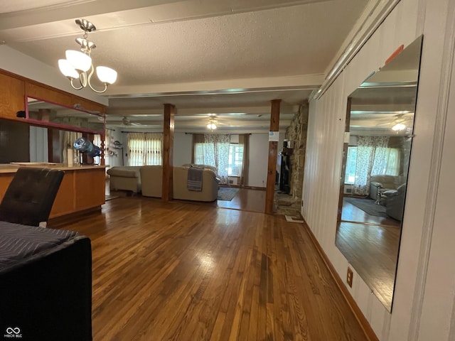 7725 S Oak Dr, Indianapolis, IN 46227 - living room featuring a ceiling fan, wood finished floors, a chandelier, a stone fireplace, and a textured ceiling